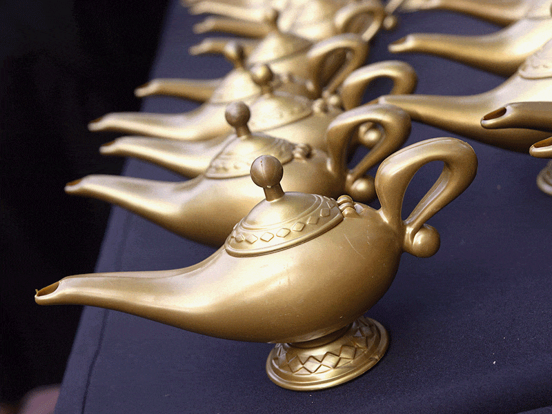 Harvard Extension School gold lamps lined on a table.